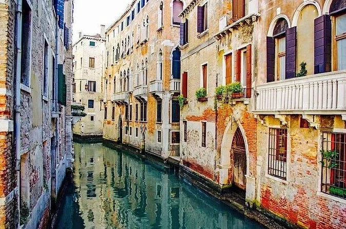 A quiet Venetian campo with an outdoor stone staircase, away from the crowds